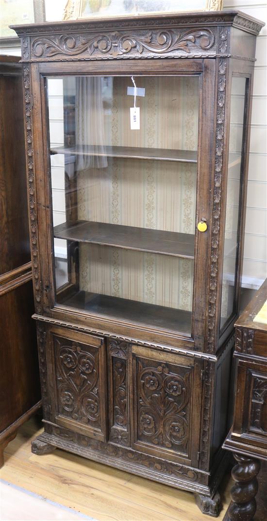 A Spanish carved walnut display cabinet,19th century, W.87cm